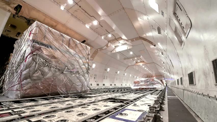Inside the cargo bay of the aircraft. view of the baggage compartment of a cargo plane. cargo hold area of a modern-day commercial cargo aircraft. Pallet timelapse, loading space. Global logistics.