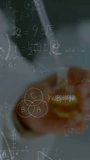 Vertical video: Senior man lowering pipette in lab causing math overlay tracking hands measuring. Dropper, vessel, chalkboard, diagrams, laboratory, glasses, vertical video - Powered by Shutterstock - Get 15% off with code: PIKWIZARD15