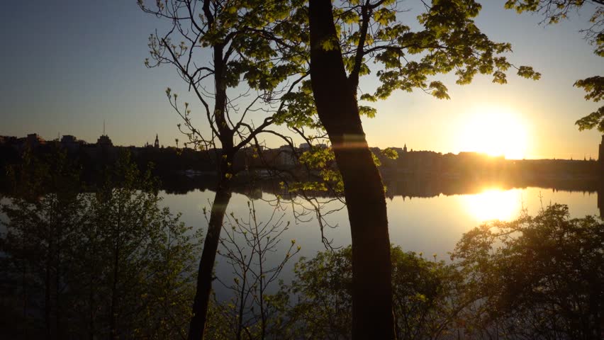 Stockholm, Sweden A sunrise view of the city and City Hall from the Langholmen island, a city park, over the water.