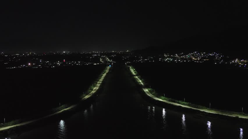 Aerial View of Waterway and City Lights at Night