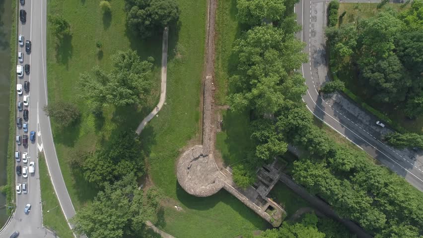 Aerial view of the ancient city walls and circular bastion surrounded by green parkland and urban roads in Ferrara, Emilia-Romagna, Italy.
