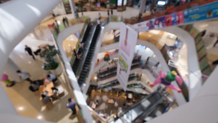 Shopping mall interior with escalator and people blurred modern retail center, blurred shopping mall interior with escalator and people modern multilevel retail center, busy shopping mall interior