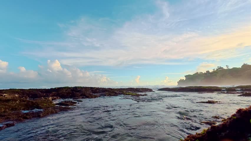 Tidal coastal rocks and shallow pools at sunset