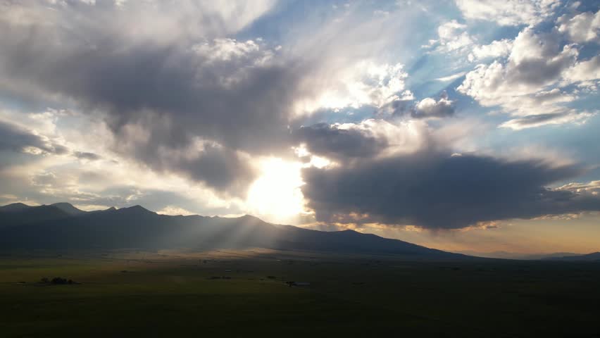 Sun Rays Between Clouds on Idyllic Countryside Landscape, Sunset Above Hills and Valley, Panoramic Drone Shot