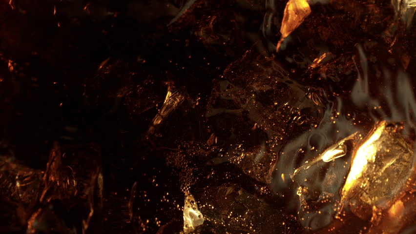 Super Slow Motion Shot of Swirling Cream Mixing in Coffee with Ice Cubes at 1000fps.