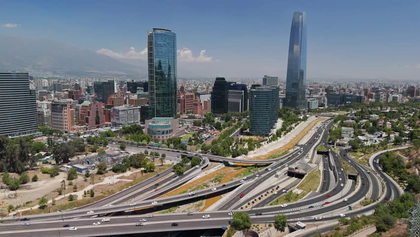 Expansive aerial perspective of santiago, chile, featuring modern skyscrapers and a complex highway interchange