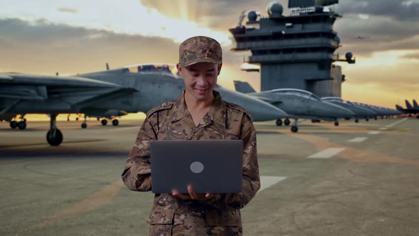 Asian Man Soldier Using A Laptop And Pointing To Side While Standing On Aircraft Carrier