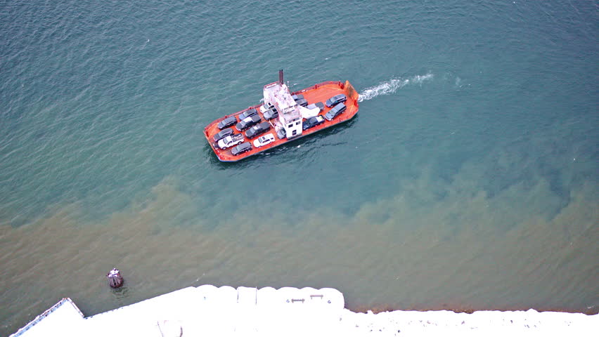 Drone view of a ferry transporting cars over the St. Marys River near Sugar Island.