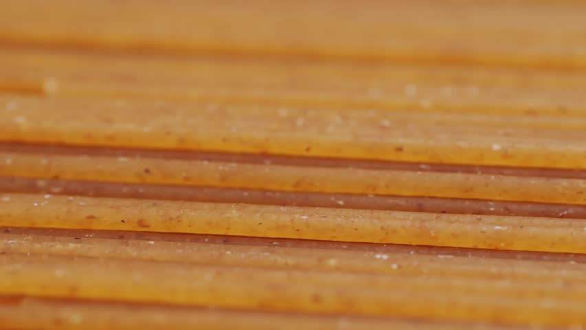 Wholegrain noodle background. Organic whole wheat spaghetti pasta, raw and dry.