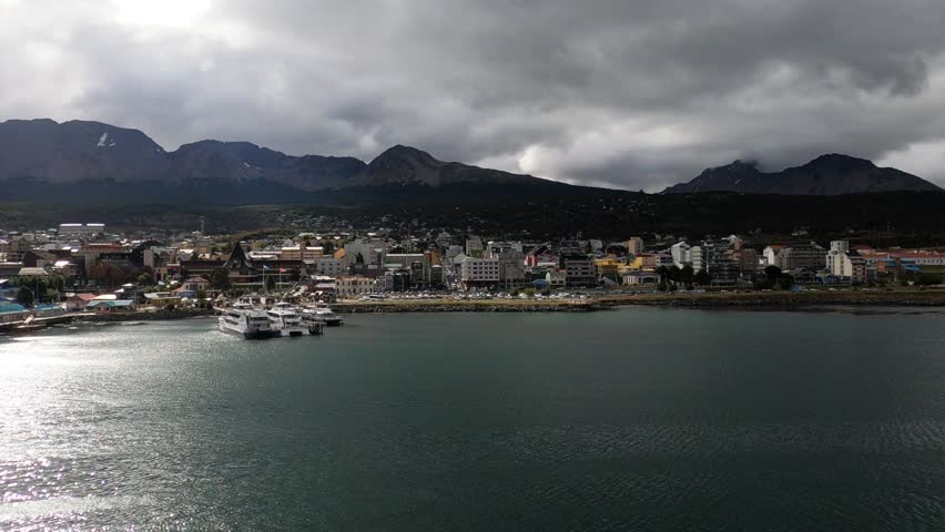 Scenic view of Ushuaia harbor with mountains and dramatic sky in Tierra del Fuego, Argentina