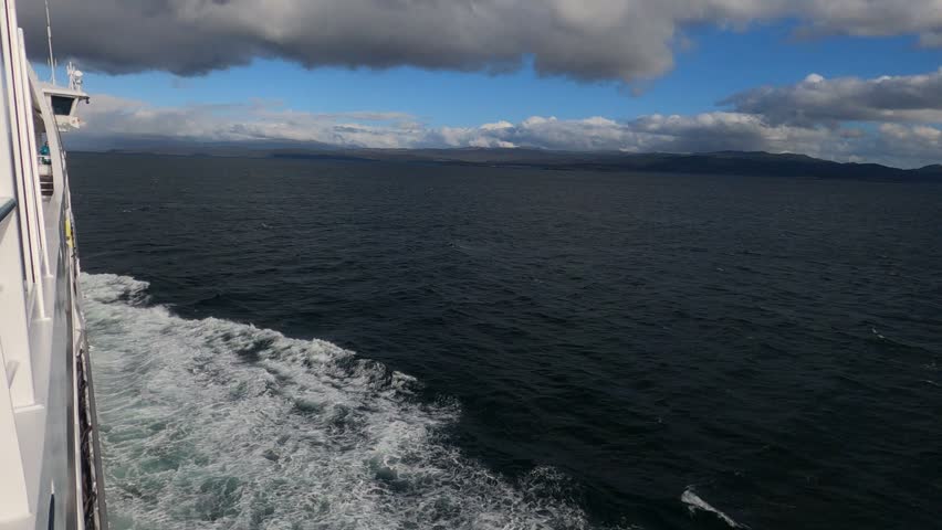 View from expedition cruise ship sailing from Ushuaia toward Antarctica across Beagle Channel, Tierra del Fuego, Argentina