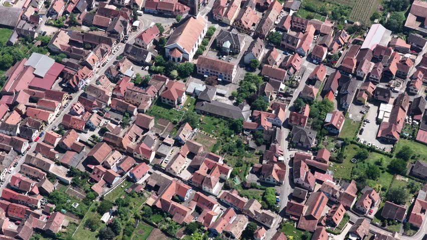 Aerial view of the traditional red-tiled rooftops and historic church spire in the old town of Selestat, Grand Est, France.