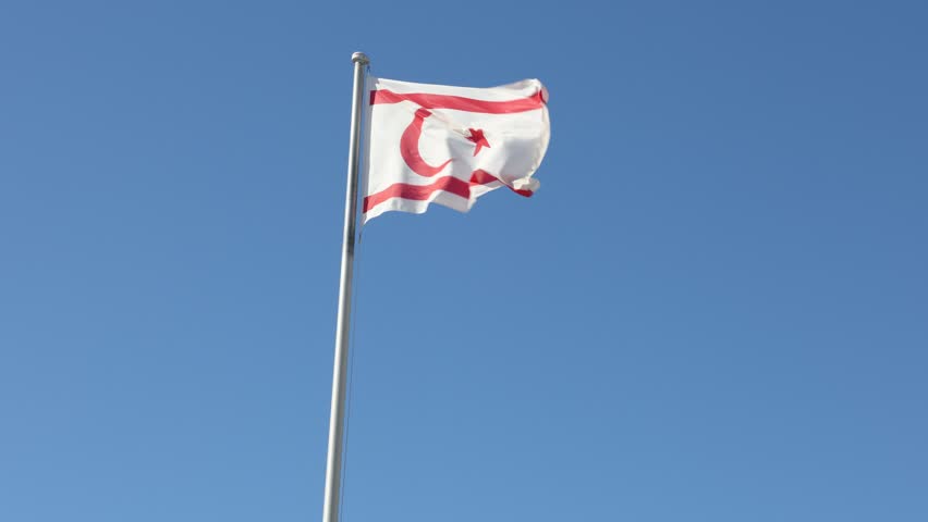 Turkish Republic of Northern Cyprus Flag waving in blue sky. Northern Cyprus.