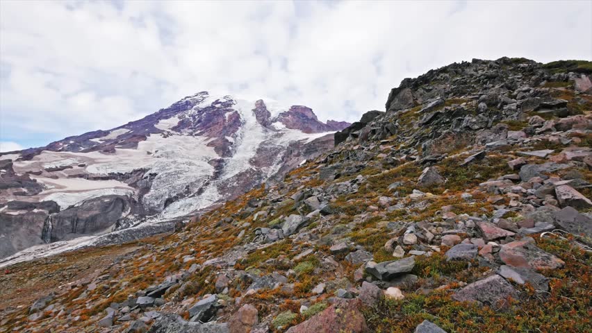 Footage from the rugged Skyline Trail in Mount Rainier National Park, Washington, looking toward the snow-covered slopes and glaciers of Mount Rainier. The view from Panorama Point offers stunning alp