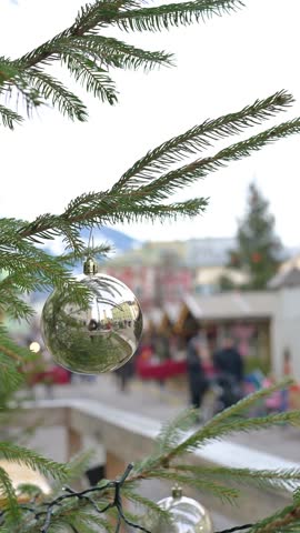Christmas Tree Ornament Close Up with Blurred Holiday Market Background