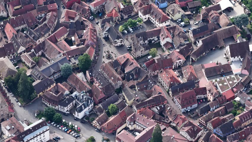 Aerial view of the historic town center of Ribeauville featuring traditional red-tiled rooftops and narrow streets in Ribeauville, Grand Est, France.