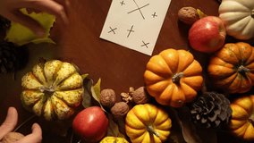 Hands arranging autumn harvest with pumpkins, pinecones and apples on warm wooden table target card for text, scattered leaves, soft warm lighting, closeup tabletop composition ideal for seasonal - Powered by Shutterstock - Get 15% off with code: PIKWIZARD15
