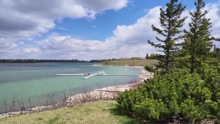 Slow motion tracking shot boat dock with sailboats and boat launch at South Glenmore Park Calgary Alberta Canada
