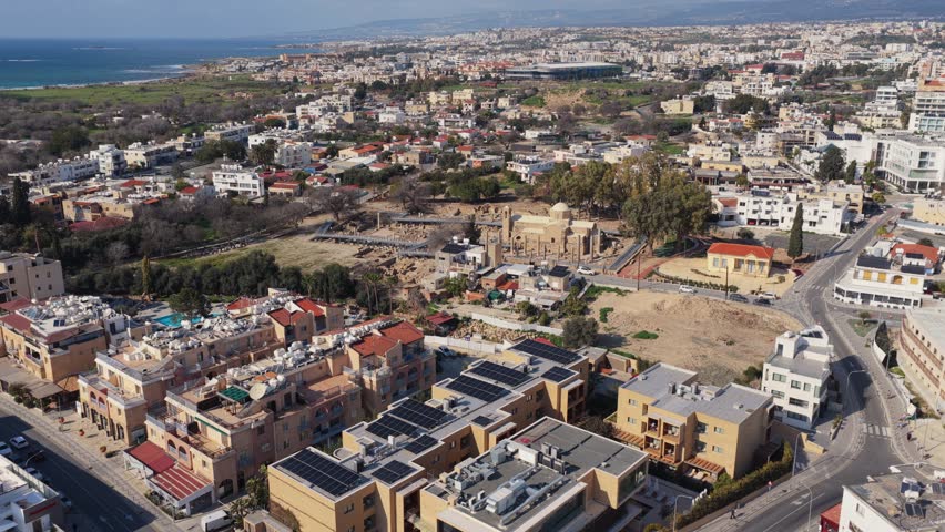 Aerial drone shot of pafos city in cyprus showing ancient ruins of panagia chrysopolitissa and town.