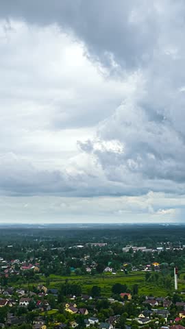 Aerial view of clouds drifting past over a rural village.