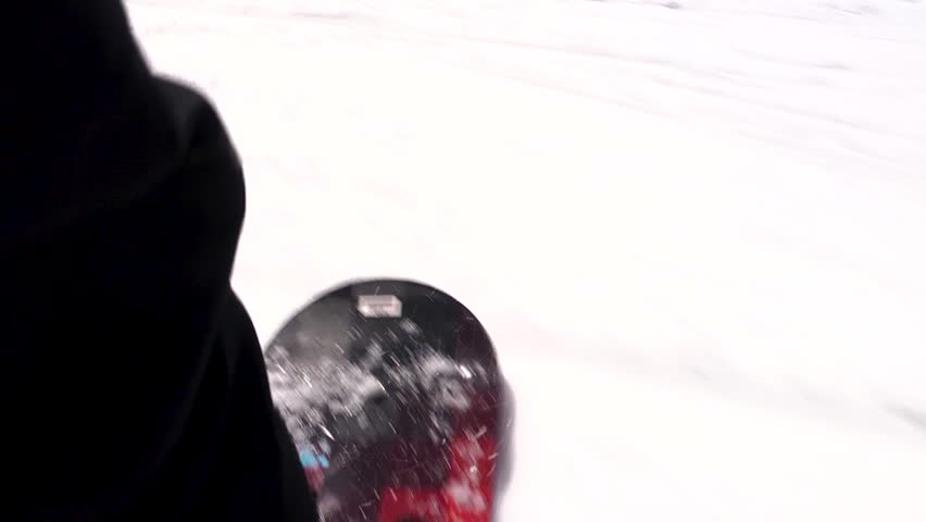 Close up of snowboard going down the mountain