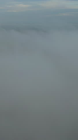 Clouds drift over the forest in a beautiful and refreshing natural setting.