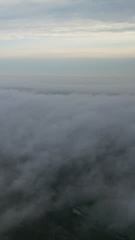 Clouds drift over the forest in a beautiful and refreshing natural setting.