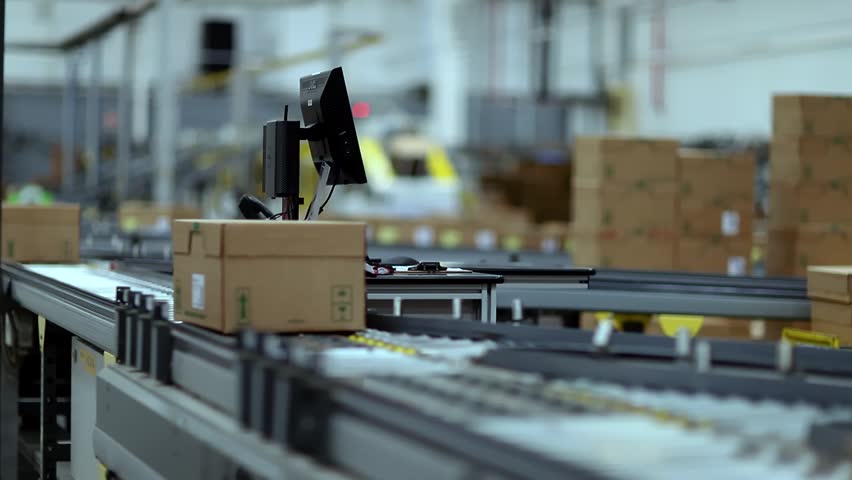 Cardboard boxes on the conveyor belt are isolated. Distribution warehouse. E-commerce, storage, delivery, and packaging service concept. 09-10-2025 