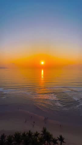 Golden Sunset Over Ocean Waves and Tropical Beach