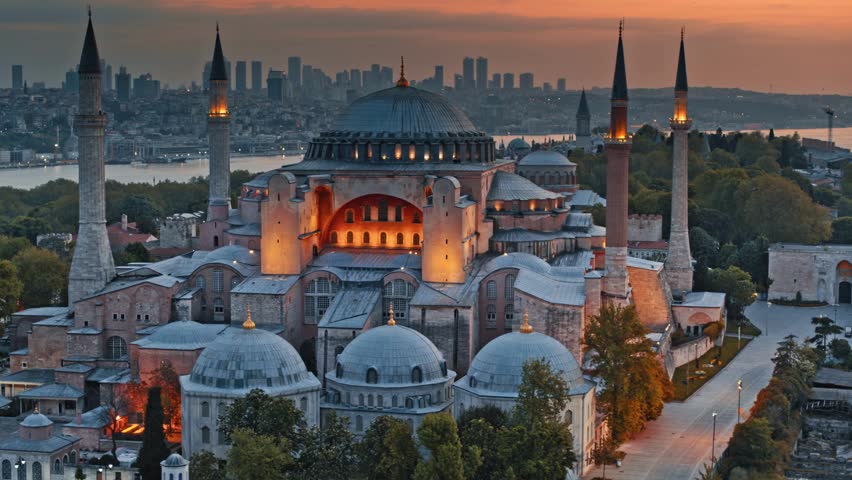 Aerial close-up of illuminated Hagia Sophia grand mosque in Istanbul during beautiful dusk.