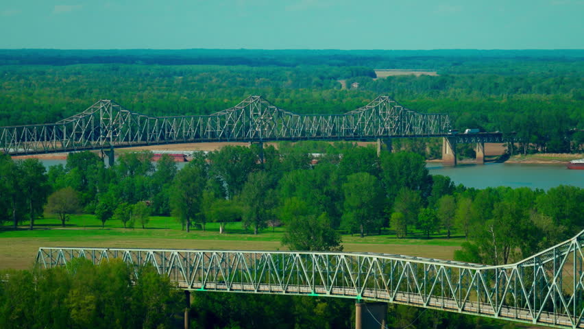 Two historic iron truss bridges crossing the confluence of the Mississippi and Ohio Rivers in Cairo, Illinois.