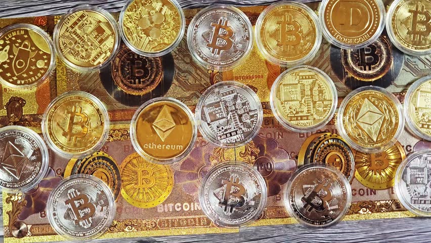 gold plated bitcoin note and physical cryptocurrency commemorative coins, tokens of Bitcoin BTC, Ethereum ETH, Ripple XRP, Dogecoin, Stellar XLM, collectible novelty items