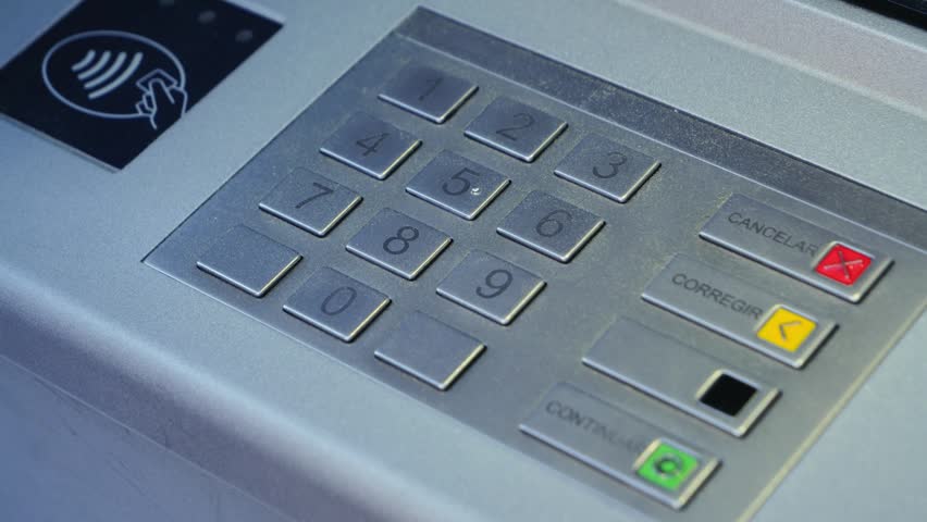 Close-up of hand entering PIN code at ATM, concept of banking security and transactions. High quality 4k footage