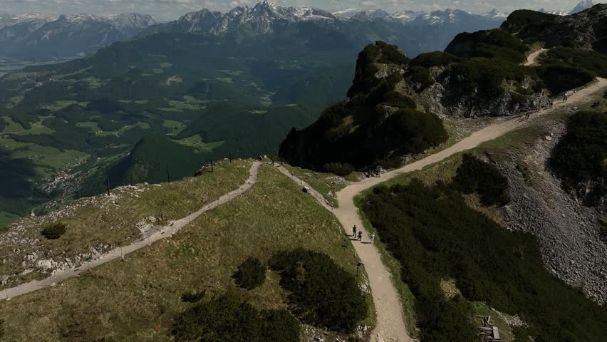 Austria cinematic drone flight above Untersberg peak and steep alpine cliffs near Salzburg. Stunning aerial footage of Austrian Alps mountains and dramatic rocky landscape in 4K.