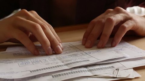 Women's hands revises paper bills (HD)