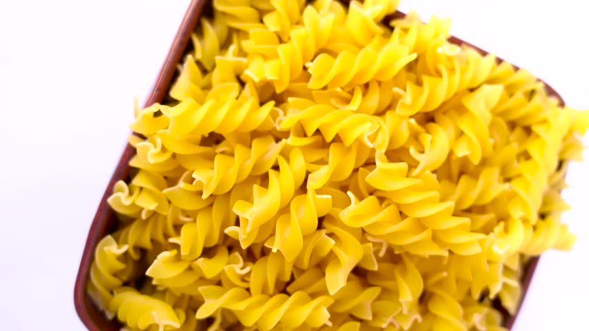 Pile of fusilli pasta twists uncooked dry food carbohydrate ingredient uncooked dry food carbohydrate ingredient
