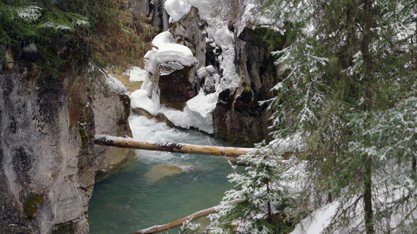 River running through the narrow canyon walls of Johnston Canyon in winter.