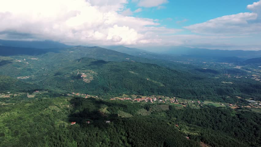 Vast mountain panorama. Wide mountain landscape under bright clouds