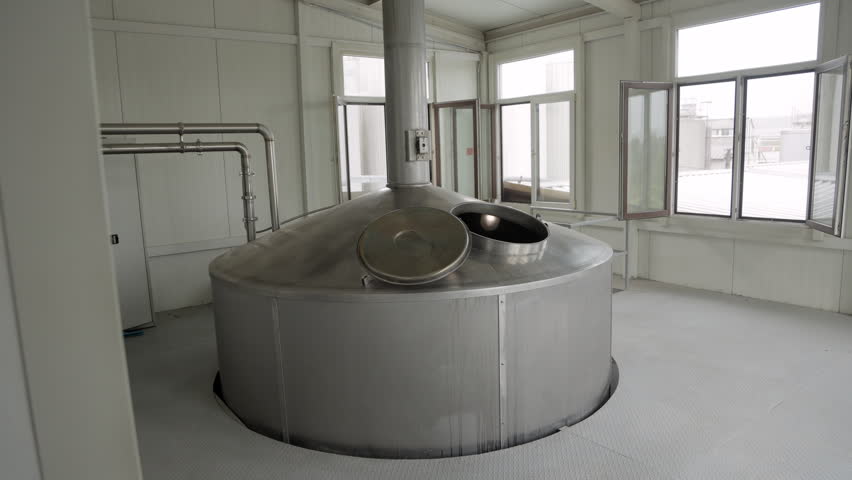 Modern beer brewery equipment preparing malt for the brewing process in a clean industrial facility