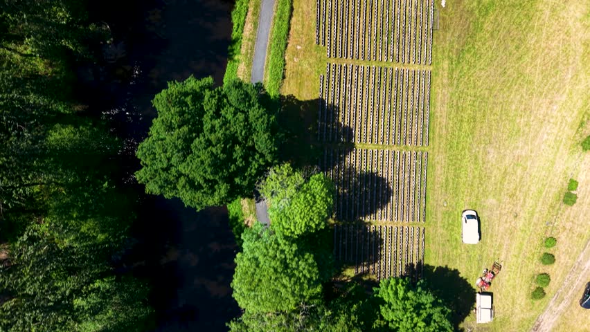 Top down drone flight above Nantes-Brest Canal with bridge, lock and waterfall in Brittany France 4K