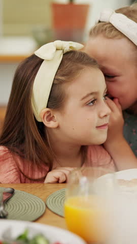 Food, secret and children at lunch in home with gossip, conversation or bonding together. Talking, health and girl kids at meal in dining room for confidential information, private story or whisper.
