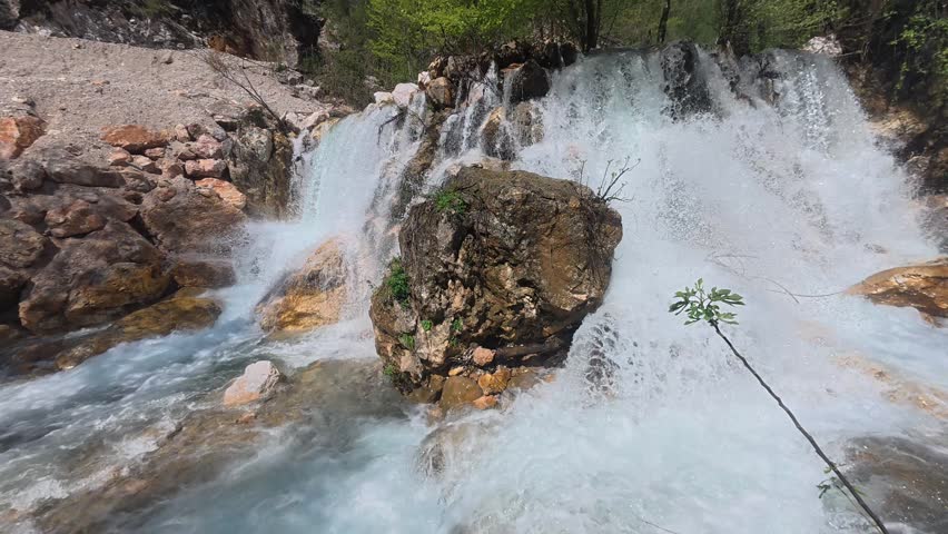 Rushing clear waterfall. Waterfall flowing rocks. High quality 4k footage