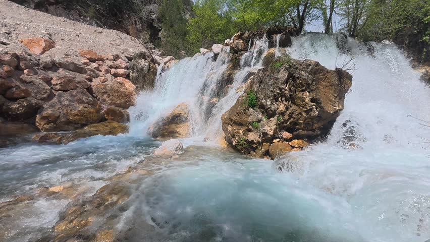 Rushing clear waterfall. Waterfall flowing rocks. High quality 4k footage