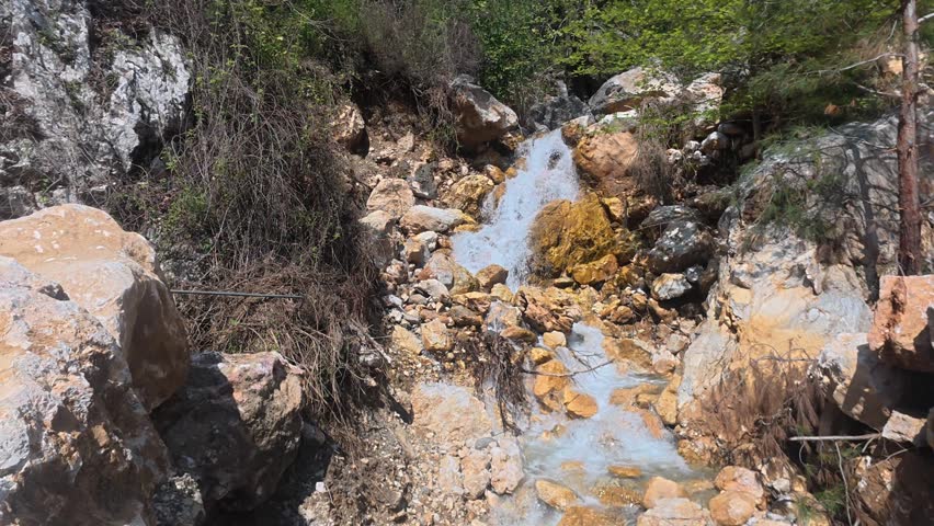 Rushing clear waterfall. Waterfall flowing rocks. High quality 4k footage