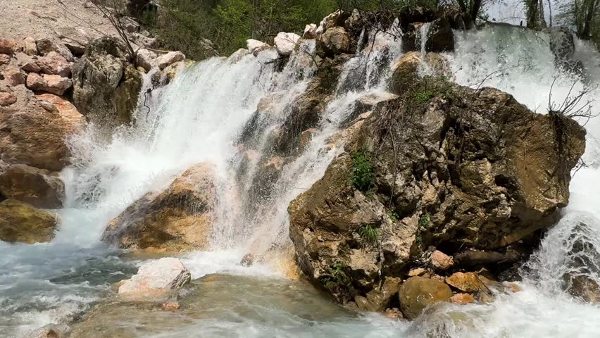 Rushing clear waterfall. Waterfall flowing rocks. High quality 4k footage