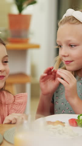 Food, whisper and children at lunch in home with gossip, conversation or bonding together. Talking, health and girl kids at meal in dining room for confidential information, private story or secret.