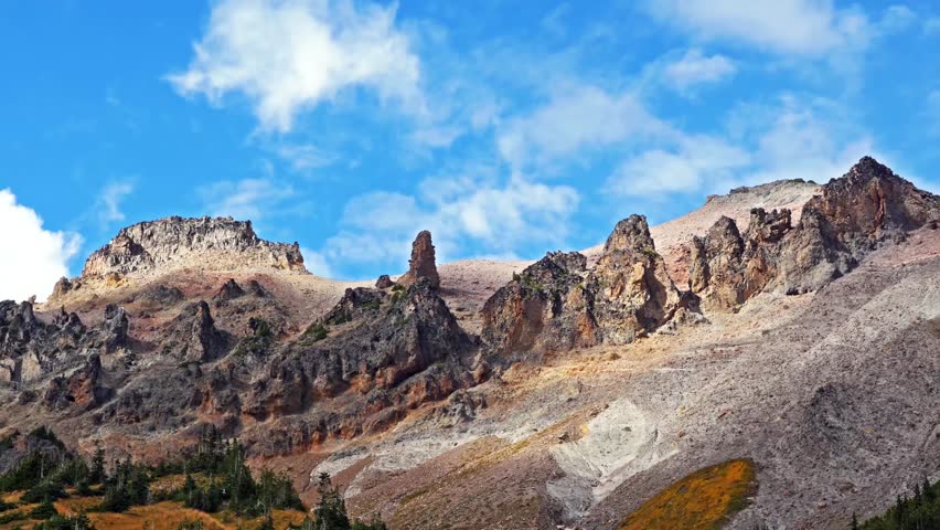Scenic footage of the rugged mountain landscape and peaks along the Glacier Basin Trail in Mount Rainier National Park, Washington. This popular hiking trail offers stunning views of glaciers, expansi