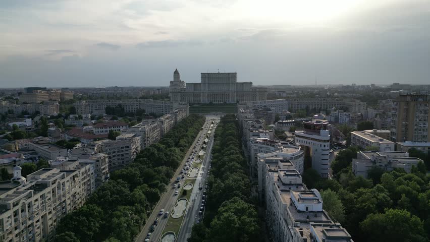 Aerial view of the Palace of the Parliament in Bucharest, Romania. Cinematic drone shot of the massive communist-era government building on a clear winter day