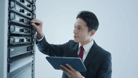 A male engineer inspecting a server and the concept of digital technology. - Powered by Shutterstock - Get 15% off with code: PIKWIZARD15