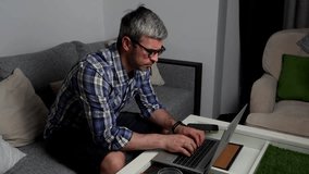 Remote worker using laptop late at night at home Freelancer working on computer in home office evening - Powered by Shutterstock - Get 15% off with code: PIKWIZARD15